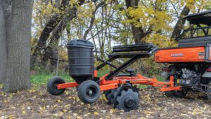 New Land Pride FPS Series Food Plot Seeders in a forested area attached to a Kubota RTV.