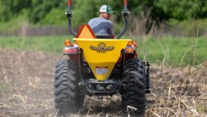 New Land Pride FSP Series Spreader attached to a tractor seeding a plot of land.
