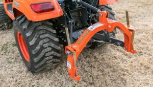 New Land Pride QH05 Quick-Hitch in a grassy field attached to Kubota equipment.