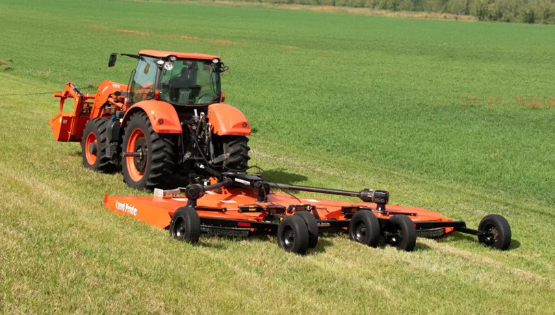 New Land Pride RC5020 Rotary Cutters mounted to a Kubota tractor in a green field.