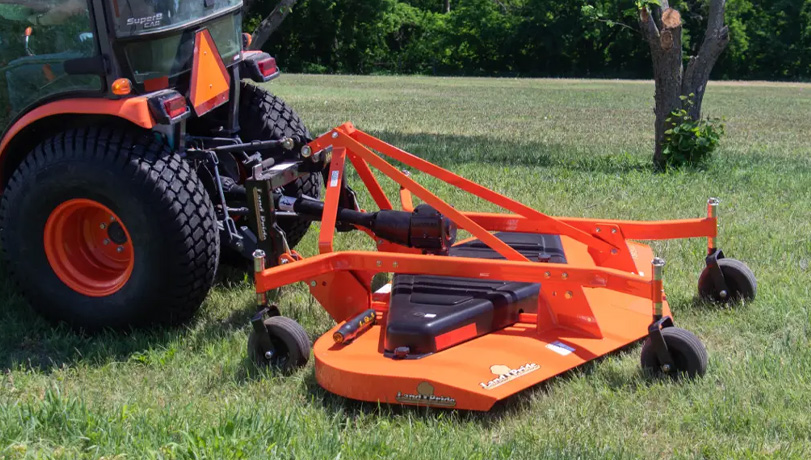 New Land Pride FDR25 Series Grooming Mowers on a green field attached to a Kubota tractor.