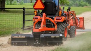 Kubota tractor with a Land Pride RB16 Series Rear Blade attached to the back.
