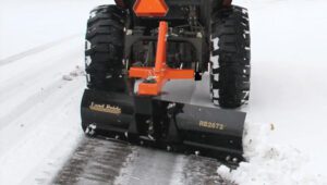 Kubota tractor with a Land Pride RB26 Series Rear Blade attached to the back.
