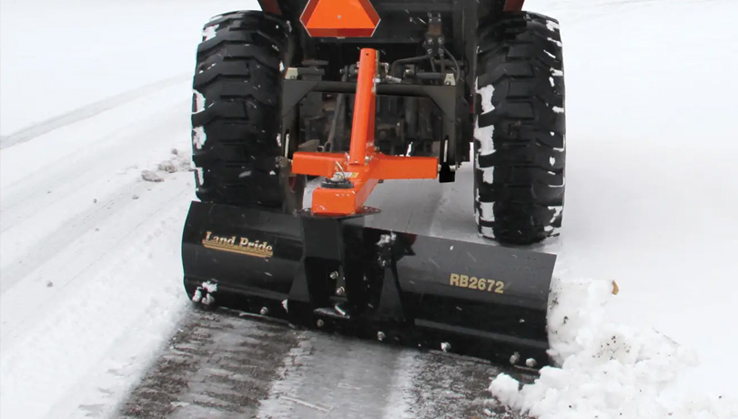Kubota tractor with a Land Pride RB26 Series Rear Blade attached to the back.