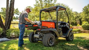 Person loading up a Kubota RTV520 Mid-Size Utility Vehicle while doing some gardening.