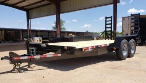 Currahee Flatbed Trailer parked on a jobsite underneath an awning.