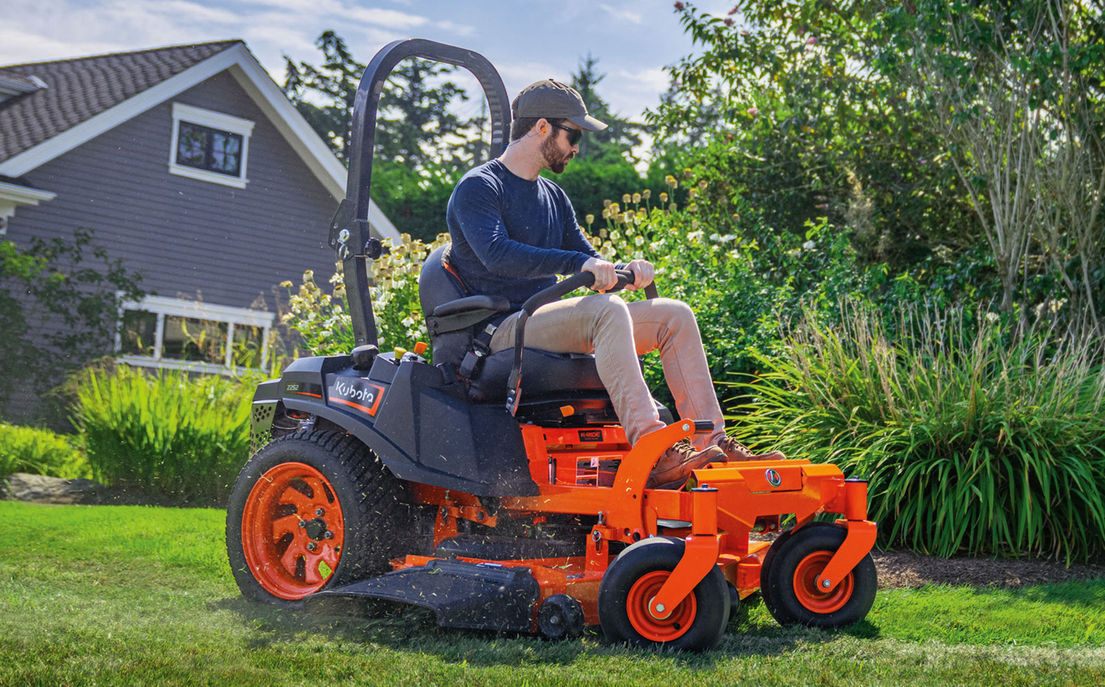 Person on a Z-Series zero-turn Kubota mower.