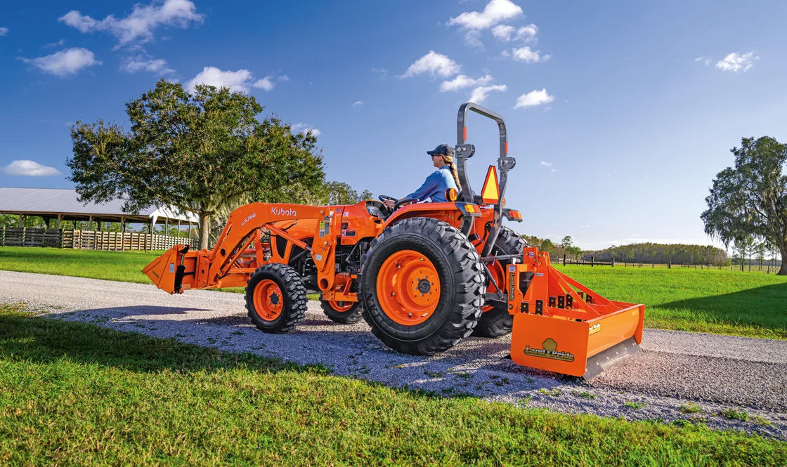 Kubota Excavator in a residential area construction site digging up and clearing land.