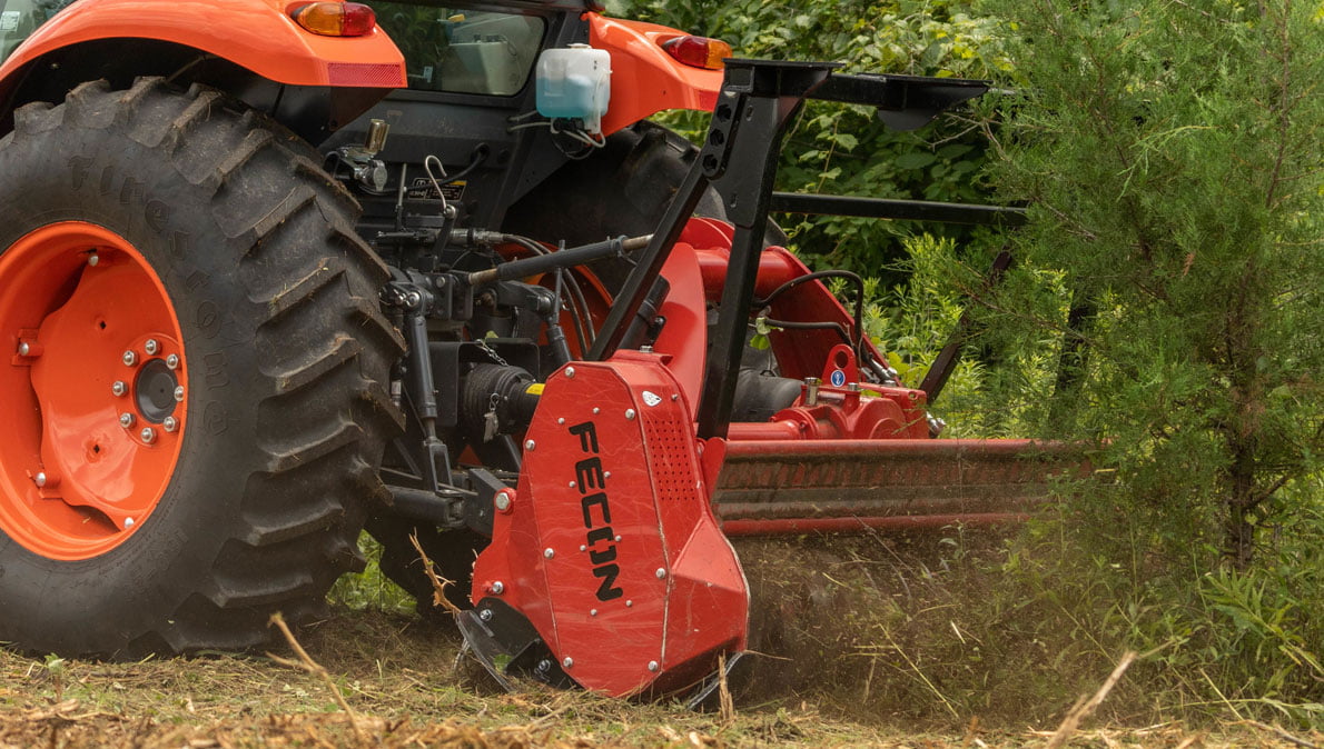 Fecon mulching attachment on a Kubota tractor.