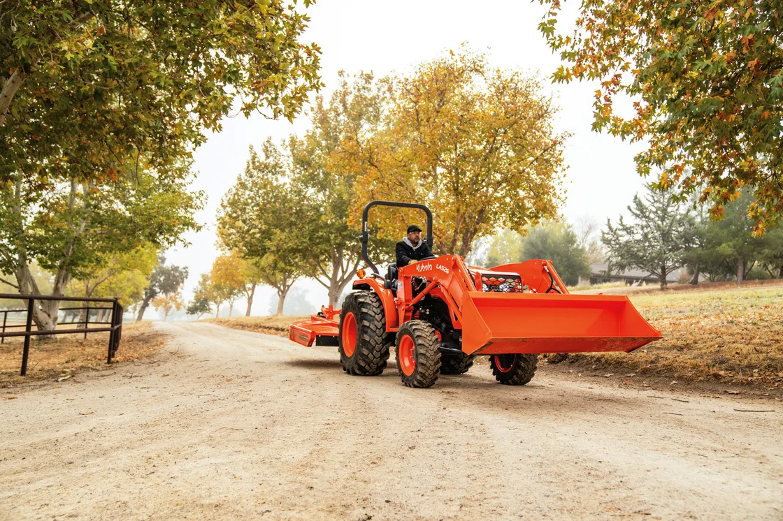 Kubota Excavator in a residential area construction site digging up and clearing land.