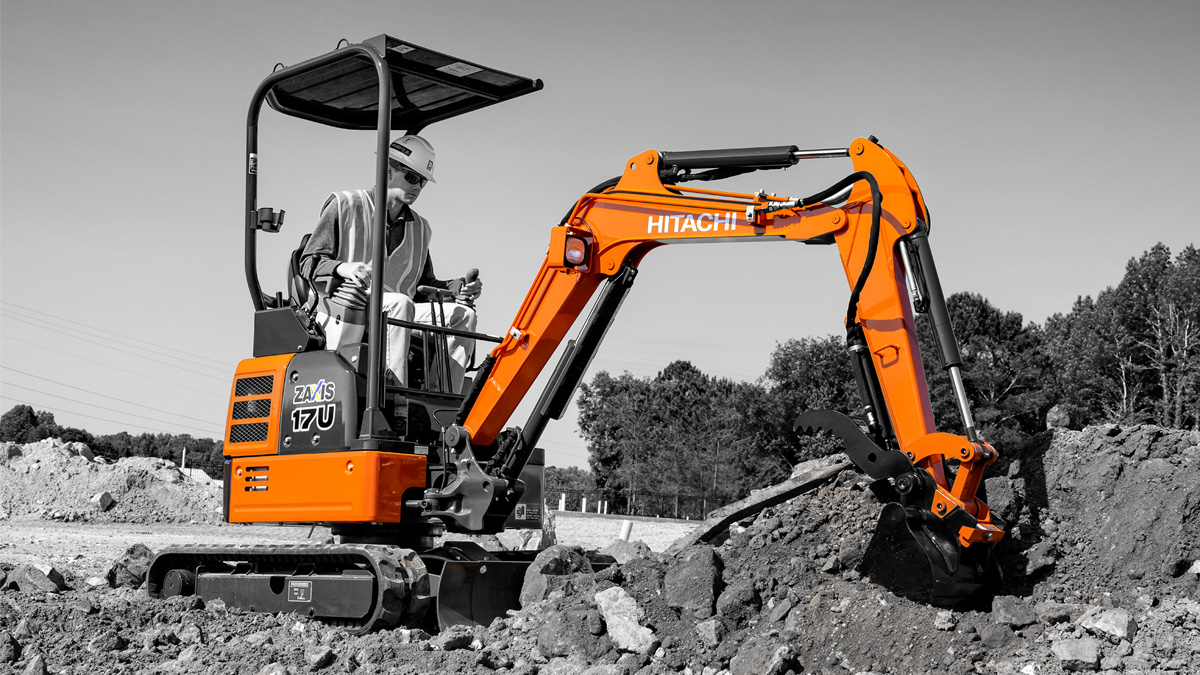 Multiple Kubota tractors in a green pasture.