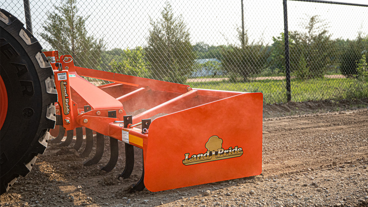 Land Pride equipment attached to the back of a Kubota tractor.