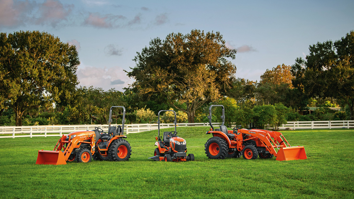 A variety of Kubota equipment in a green field.